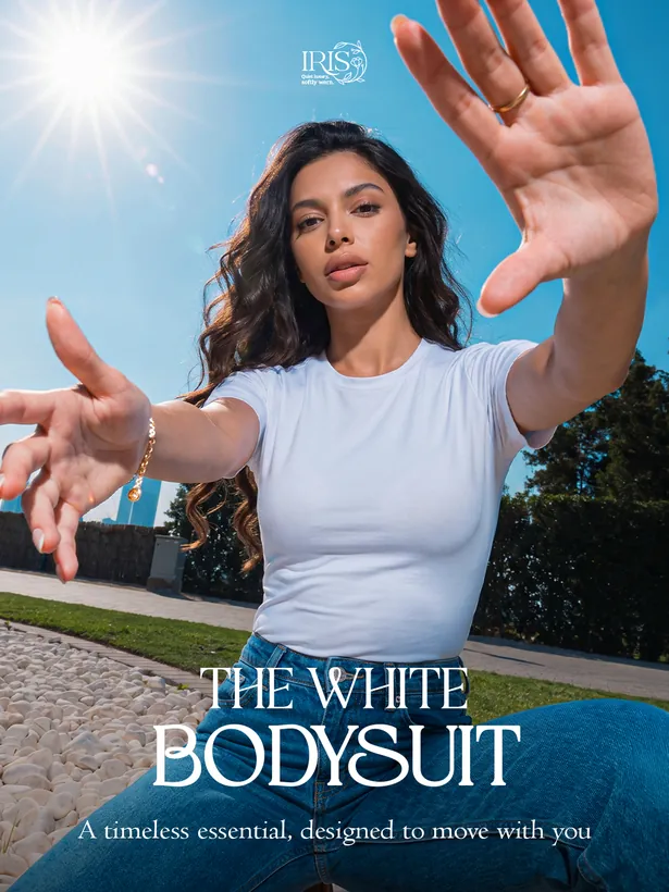 IRIS campaign image: a model in a white bodysuit reaching toward the camera under hard sun, with the headline The White Bodysuit.